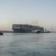 In this photo released by Suez Canal Authority, the Ever Given, a Panama-flagged cargo ship is pulled by tugboats, in the Suez Canal.